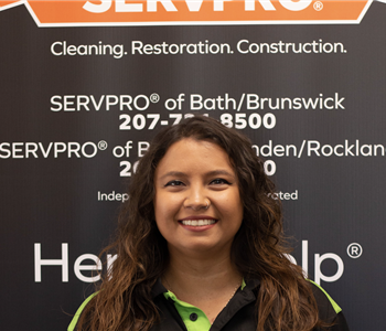 SERVPRO employee in front of logo