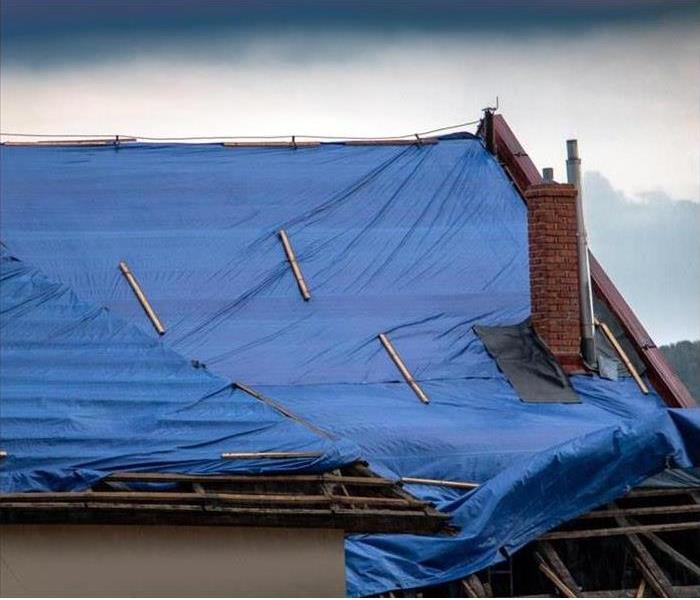 Tarp on top of damaged roof