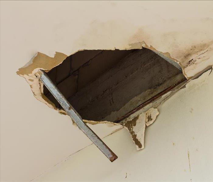 Hole in ceiling due to a water leak above the ceiling.