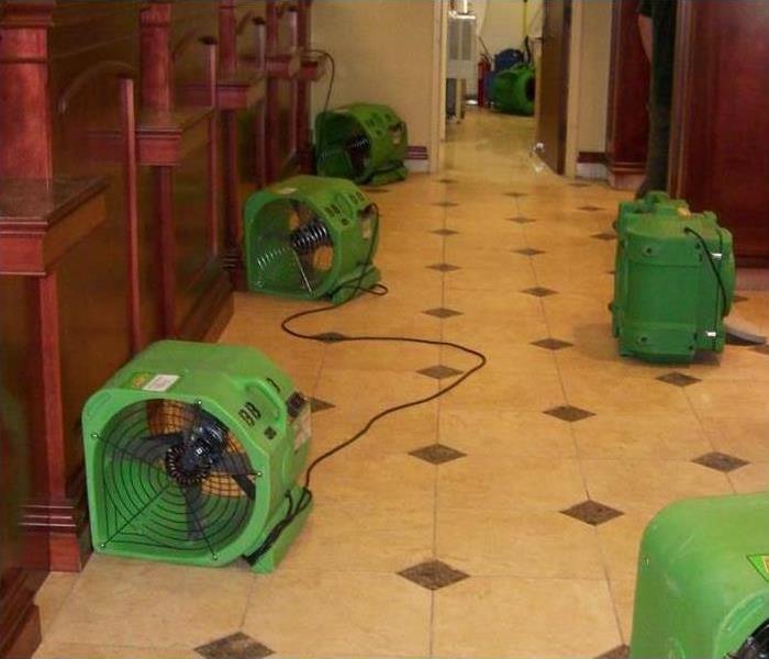six air movers placed on the floor of a bank building